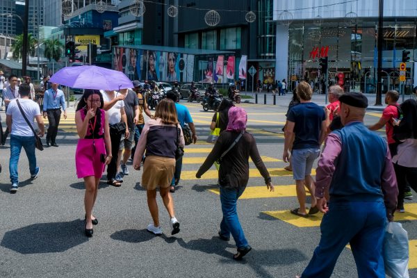 KUALA LUMPUR, MALAYSIA : OCTOBER 25, 2018 : People crossing road at MRT (Mass Rapid Transit) Bukit Bintang station. Bukit Bintang is a tourist attraction place for shopping, eat and sightseeing.