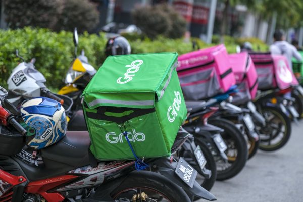 KUALA LUMPUR, MALAYSIA - MARCH 22, 2020 : Food delivery service rider for Foodpanda and GrabFood. Food delivery service through its mobile application.
