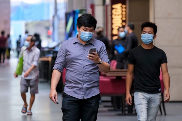 KUALA LUMPUR, MALAYSIA - MAY 04, 2020: People wearing face mask with social distancing walk at famous shopping district, Pavilion Bukit Bintang. Malaysia Coronavirus disease 2019 (COVID-19) outbreak.