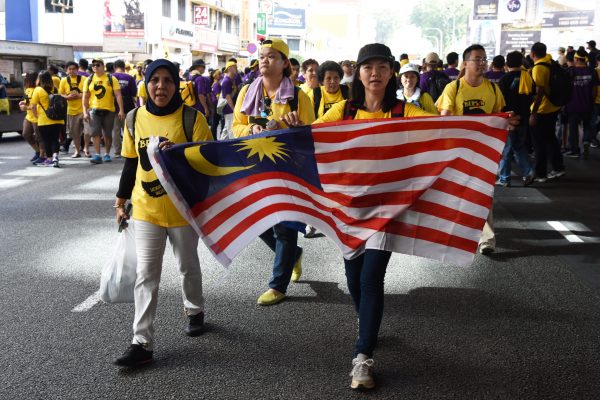 Kuala Lumpur, Malaysia  November 19, 2016 Rally goers hold a Malaysian flag during the Bersih 5 rally to call for a new and cleaner electoral system in Malaysia.